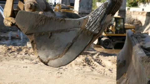 Excavator at a construction site drives by camera. Stock Footage 97300991