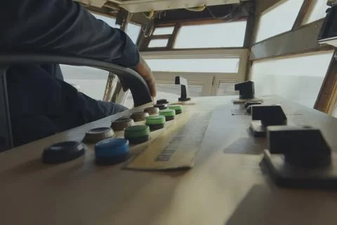 Excavator control panel buttons and the operator's hand nearby. Stock Photos