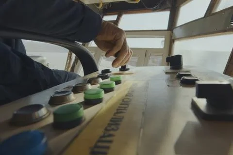 Excavator control panel buttons and the operator's hand nearby. Stock Photos