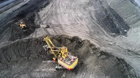 The excavator is developing a coal-based platte. Stock Photos