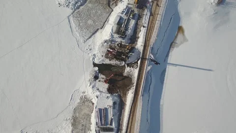 An excavator dig the ground drone view winter bridge construction Stock Footage 169323955