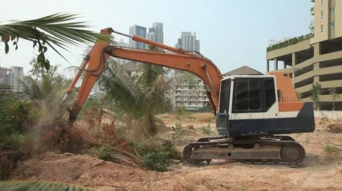 Excavator Digger on a construction site equates land clearing a building site Stock Footage 47046353