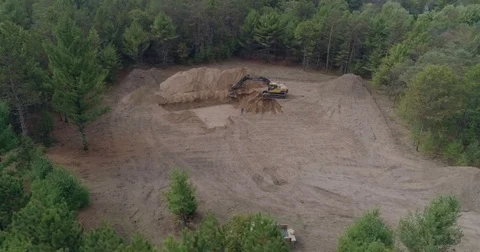 Excavator Digging Basement Hole in Woods 4k Stock Footage 81754153