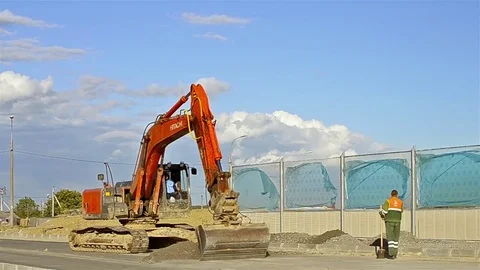 Excavator digging on construction high-speed road Stock Footage 77175973