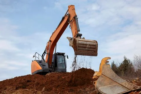 Excavator Digging at Construction Site Stock Photos