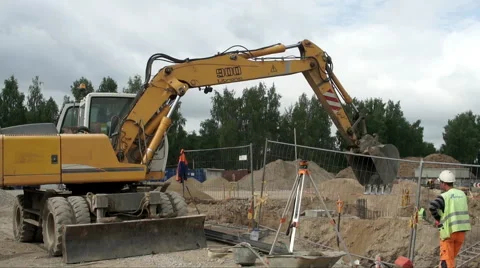 Excavator digging at construction site with works wide shot Stock Footage 51353104