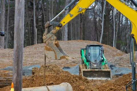 Excavator digging a deep trench Stock Photos
