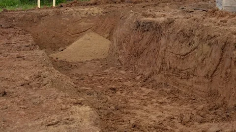 Excavator digging foundation trench on construction site 動画素材 341294466