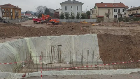Excavator digging foundations in arona town italy Stock Footage 280893224