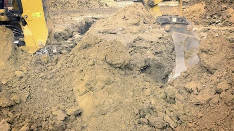 Excavator is digging foundations. Construction machinery, ground works Видео 87420317