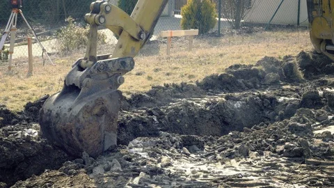 Excavator is digging foundations. Construction machinery, ground works Видео 87473790