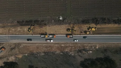 Excavator digging ground and load it into dump truck on road. Stock-Footage 152287755