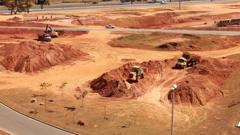 Excavator digging up the ground and loading dirt into a dump truck Stock Footage 280253298