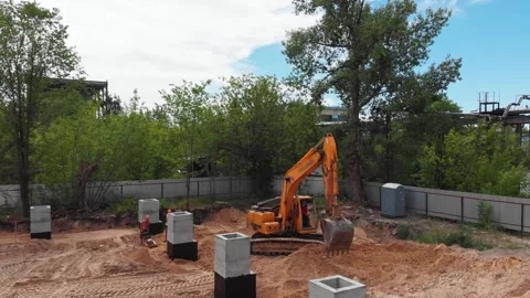 Excavator digging ground at a building foundation construction site Stock Footage 347833115