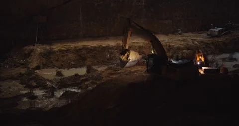 Excavator digging ground at construction building site at night. BMPCC 4K Stock Footage 125847908