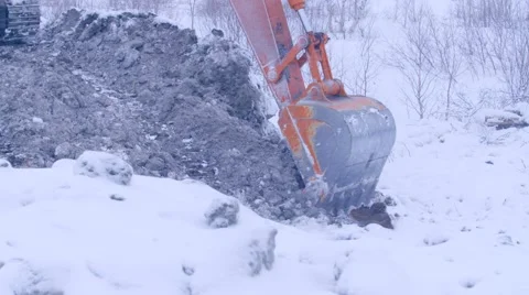 Excavator is digging the ground in snow winter day Stock Footage 62444922