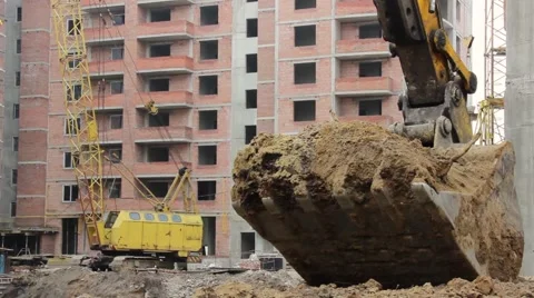 Excavator digging a hole at a construction site Stock Footage 68787779