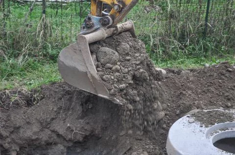 Excavator digging a hole Stock Photos