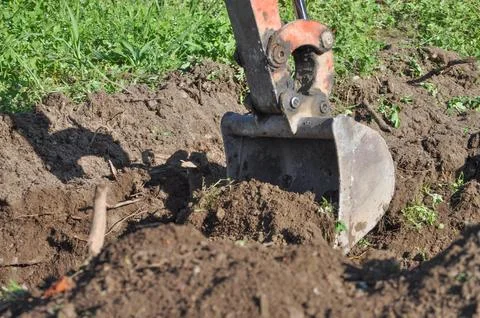 Excavator digging a hole Stock Photos