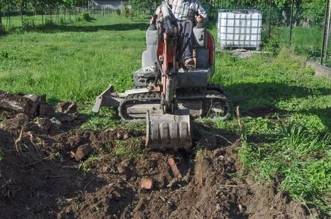 Excavator digging a hole Stock Photos