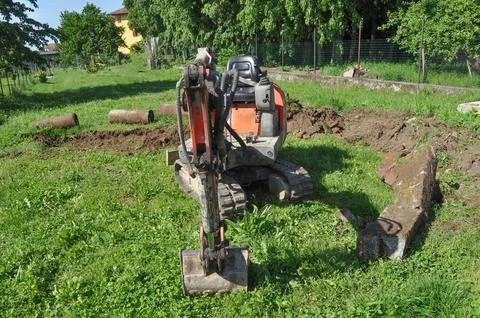 Excavator digging a hole Stock Photos