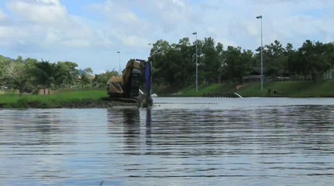 Excavator digging the lake for cable wakeboard park. Cable park industry. Stock Footage 32281102