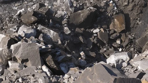 Excavator digging ore close-up. Bucket excavator rakes rock. Open pit mining. Video stock 94601296