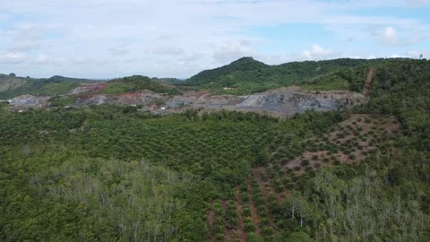 Excavator digging rocks to be loaded onto a truck in a stone mining area, b.. Stock Footage 312297443