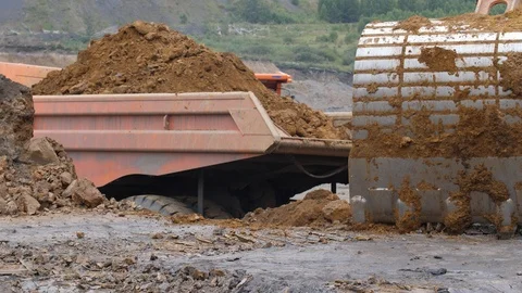 The excavator is digging the soil in close-up. Excavator loads the body of a 스톡 동영상 94603033