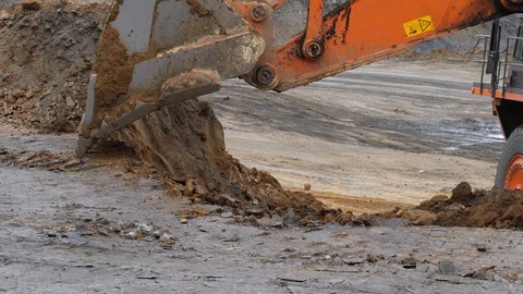 The excavator is digging the soil in close-up. Excavator bucket rakes clay soil 库存影片 94603196