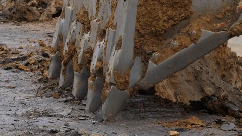 The excavator is digging the soil in close-up. Excavator bucket rakes clay soil Video stock 94603449