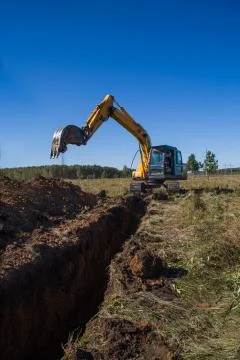 Excavator digging a trench 스톡 사진