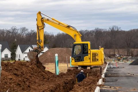 Excavator digging a trench Stock Photos