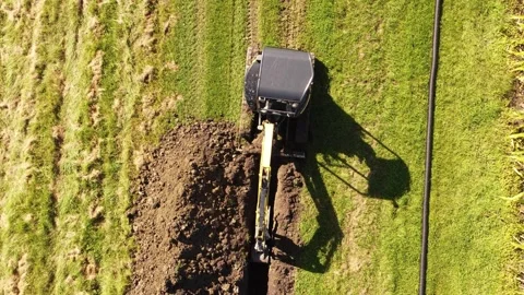 Excavator diging dranig dich from above in 4k Stock Footage 266299236