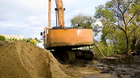 The excavator digs a deep ditch Stock Footage 222585150