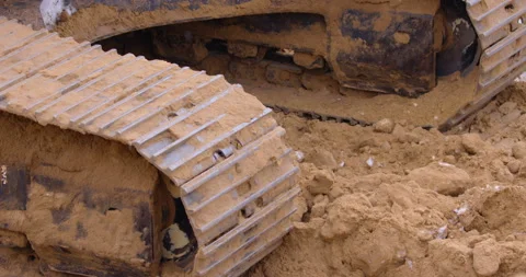 Excavator digs a ditch and pours the earth from the side Stock Footage 147611302
