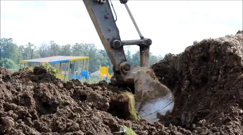 Excavator digs the earth with a bucket Stock Footage 65862179