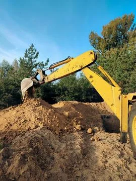 Excavator digs the foundations of the building. Digging the pit foundation a  Stock Photos