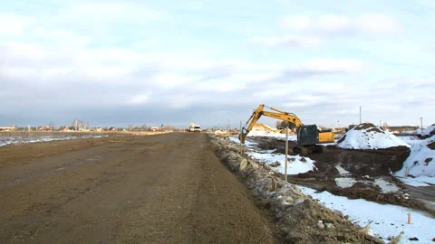 Excavator digs the ground on the construction site. Construction of the road Stock Footage 94486982