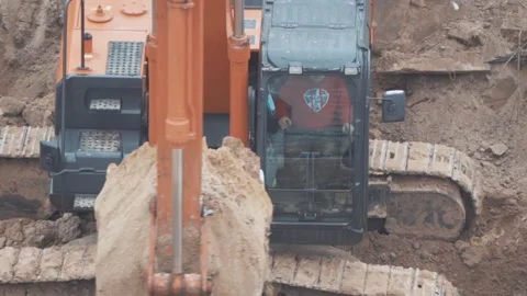 An excavator digs the ground at a construction site Stock Footage 147178407