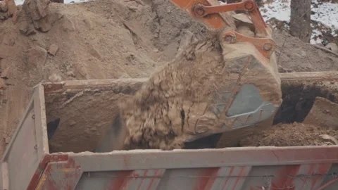 An excavator digs the ground at a construction site Stock Footage 147178669