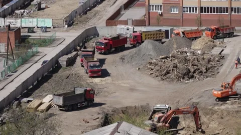 Excavator digs the ground for the future construction of an apartment build Stock Footage 253624519