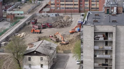 Excavator digs the ground for the future construction of an apartment build Stock Footage 253624701