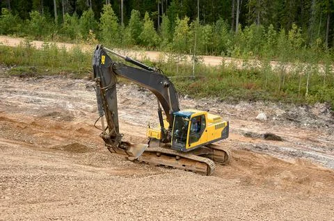 Excavator digs the ground Stock Photos