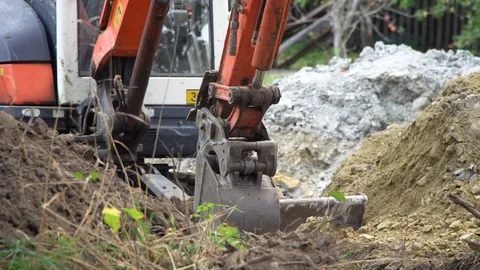 The excavator digs into the ground, preparing the foundation Stock Footage 118255136