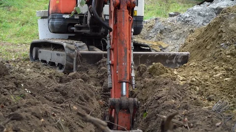 Excavator digs a hole, construction work, preparation for the foundation Stock Footage 118255098