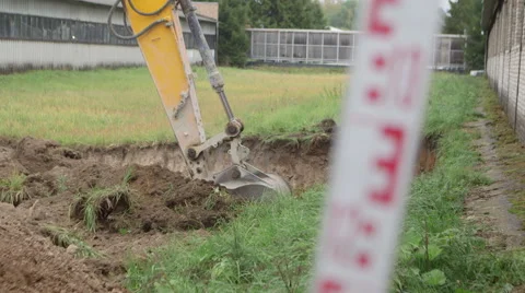 Excavator digs a hole  Stock Footage 44682606
