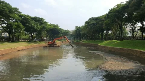 The excavator digs the sediment in the river to prevent the flood Stock Footage 219150123