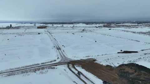 Excavator digs through field divided into square furrows Stock Footage 327803705