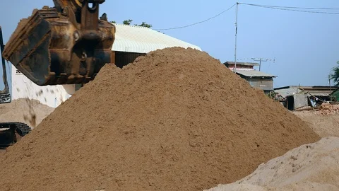 Excavator discharging and piling up sand at disposal site ( close up) Stock Footage 85873677
